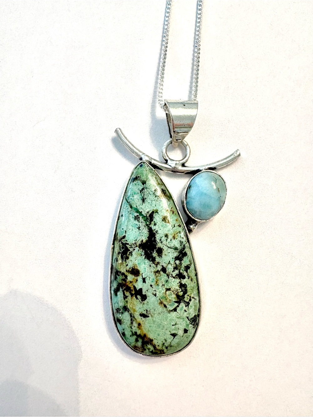 2 1/2 inch, Long African Turquoise and Moonstone  pendant on a silver chain.